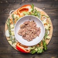 Canned beef white plate around lie ingredients vegetables and herbs on wooden rustic background top view Royalty Free Stock Photo