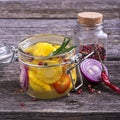 Canned colorful different vegetables Assorted glass jar with spices, oil, vinegar, salt and sugar in a simple dark