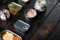 Canned fish with different assortment types of seafood, on old dark  wooden table background., with copyspace  and space for text Royalty Free Stock Photo