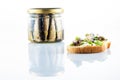 Canned food with sprats. Sandwich with fish and butter. Front view. Isolate