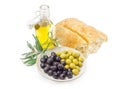 Black and green olives, olive branch, ciabatta and olive oil Royalty Free Stock Photo