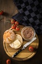 Canned liver sausage spread from long term pantry with crispy bread roll bun, butter, tomatoes and knife for snack or breakfast on Royalty Free Stock Photo