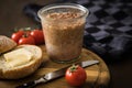 Canned liver sausage spread from long term pantry with crispy bread roll bun, butter, tomatoes and knife for snack or breakfast on