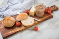 Canned liver sausage spread from long term pantry with crispy bread roll bun, butter, tomatoes and knife for snack or breakfast on