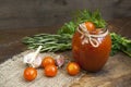 Canned marinated tomatoes in tomato juice on a wooden table Royalty Free Stock Photo