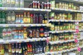 Canned mushrooms and vinegar on shelves of supermarket store