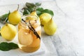 Canned pear compote with vanillin. Pear compote. Homemade delicious canned pear compote in glass jars at home on a light