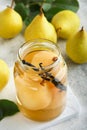 Canned pear compote with vanillin. Pear compote. Homemade delicious canned pear compote in glass jars at home on a light backgroun