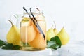 Canned pear compote with vanillin. Pear compote. Homemade delicious canned pear compote in glass jars at home on a light