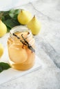 Canned pear compote with vanillin. Pear compote. Homemade delicious canned pear compote in glass jars at home on a light