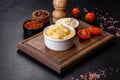 Canned pineapple chunks in a white bowl on a dark concrete background