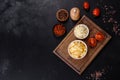 Canned pineapple chunks in a white bowl on a dark concrete background