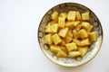 Canned pineapples in a beautiful dish on a white background.