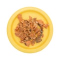 Canned salmon on a yellow plate top view