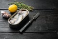 Canned sardine in oil, on black wooden table background, with copy space for text Royalty Free Stock Photo