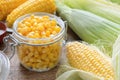 Canned sweet corn in glass jar, fresh and cooked corn cobs. Royalty Free Stock Photo