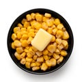 Canned sweet corn with a knob of butter in a black ceramic bowl isolated on white. Top view Royalty Free Stock Photo