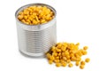 Canned sweet corn in an open metal tin next to spilled sweet corn isolated on white