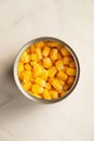 Canned sweet corn in opened tin can, top view. Royalty Free Stock Photo