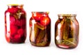 Canned tomatoes and cucumbers in a glass jar on a white background Royalty Free Stock Photo