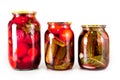 Canned tomatoes and cucumbers in a glass jar on a white background Royalty Free Stock Photo