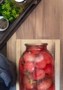 Canned tomatoes in a large glass jar