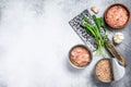 Canned tuna in a can, whole and chopped. Grey wooden background. Top view. Copy space