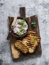 Canned tuna, cream cheese, herb spread pate and grilled bread on a cutting board, top view. Delicious tapas, appetizer, snack Royalty Free Stock Photo