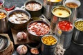 Canned vegetables, beans, fish and fruits in tin cans on black background. Food stocks Royalty Free Stock Photo