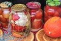 Canned vegetables in glass jars. Pickled cucumbers and tomatoes