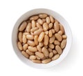Canned white beans in a plate on a white background. Top view