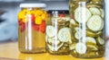 Canned yellow peppers and cucumber in a jar on wooden background,natural light Royalty Free Stock Photo