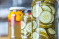 Canned yellow peppers and cucumber in a jar on wooden background,natural light Royalty Free Stock Photo