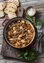 Cannellini beans beef slow-cooker stew on the wooden table, top view.