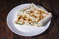 Cannelloni, cottage cheese with greens in pita bread on a plate Royalty Free Stock Photo