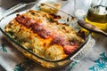 Cannelloni with spinach close up, tomato sauce, bachamel and cheese on table cloth. Traditional homemade classic italian cuisine Royalty Free Stock Photo