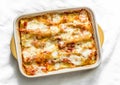 Cannelloni with spinach and ricotta baked with tomato sauce and mozzarella on a light background, top view Royalty Free Stock Photo