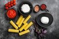 Cannelloni with spinach and ricotta, on black dark stone table background, top view flat lay Royalty Free Stock Photo