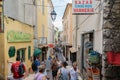 CANNES, FRANCE - August, 2018. Tourists walk on a narrow old street with shops and cafes