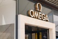 Omega luxury watch shop brand sign and logo text wall facade entrance store Swiss luxury Royalty Free Stock Photo