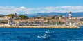 Cannes seafront panorama with lighthouse on breakwater and yacht port at French Riviera of Mediterranean Sea in France