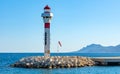 Cannes seafront panorama with lighthouse on breakwater and yacht port at French Riviera of Mediterranean Sea in France