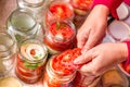 Canning fresh tomatoes with onions for winter in jelly marinade.