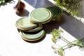 Canning lids on the kitchen table, prepared for closing glass jars, side view, close-up