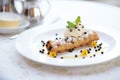 cannoli with chocolate chips on a white plate