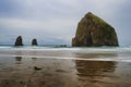 Cannon Beach Haystack Rock and Needles under cloudy skies Royalty Free Stock Photo