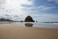 Cannon Beach, Oregon coast: the famous Haystack Rock reflects itself in the water Royalty Free Stock Photo