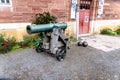 A cannon in front of a house Royalty Free Stock Photo