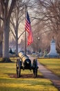 cannon in a historic military park with american flag at half-mast