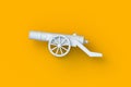 Cannon on orange background. Old weapon. Antique artillery on wheels. Vintage firearm Royalty Free Stock Photo